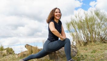 smiling woman finds inner peace through yoga in nature