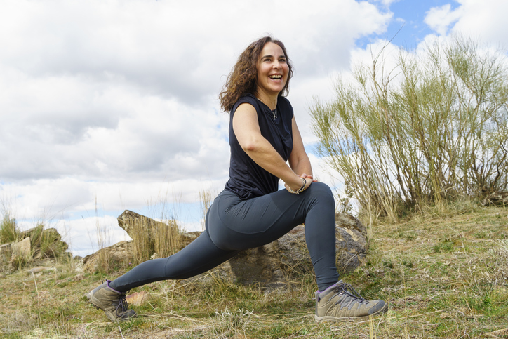 smiling woman finds inner peace through yoga in nature