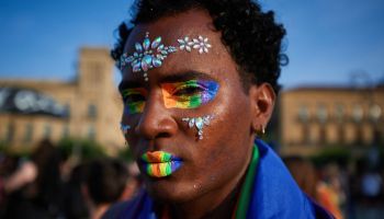 A protester with pride colors makeup takes part during the...