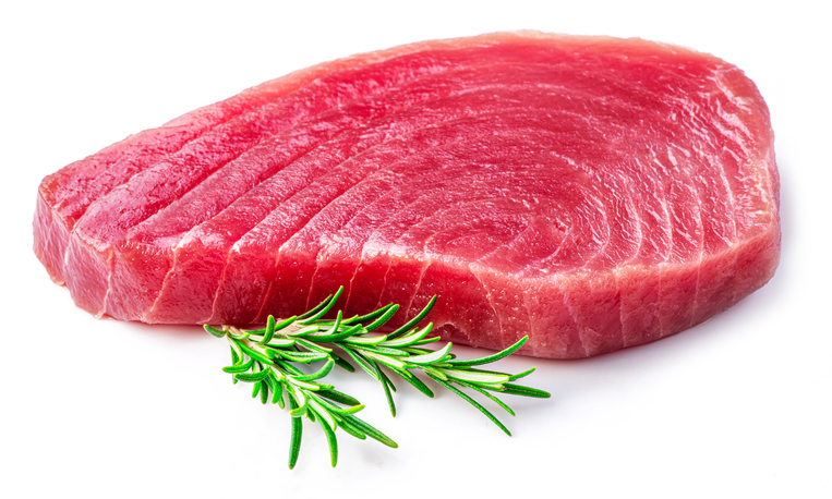 Fresh tuna steak nad rosemary twig isolated on white background.