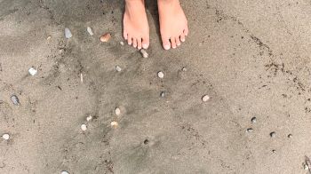 barefoot walking in the beach, nature grounding concept.